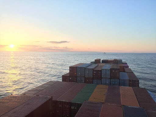 Container port with stacked cargo showing freight and forwarding services for UK operations.