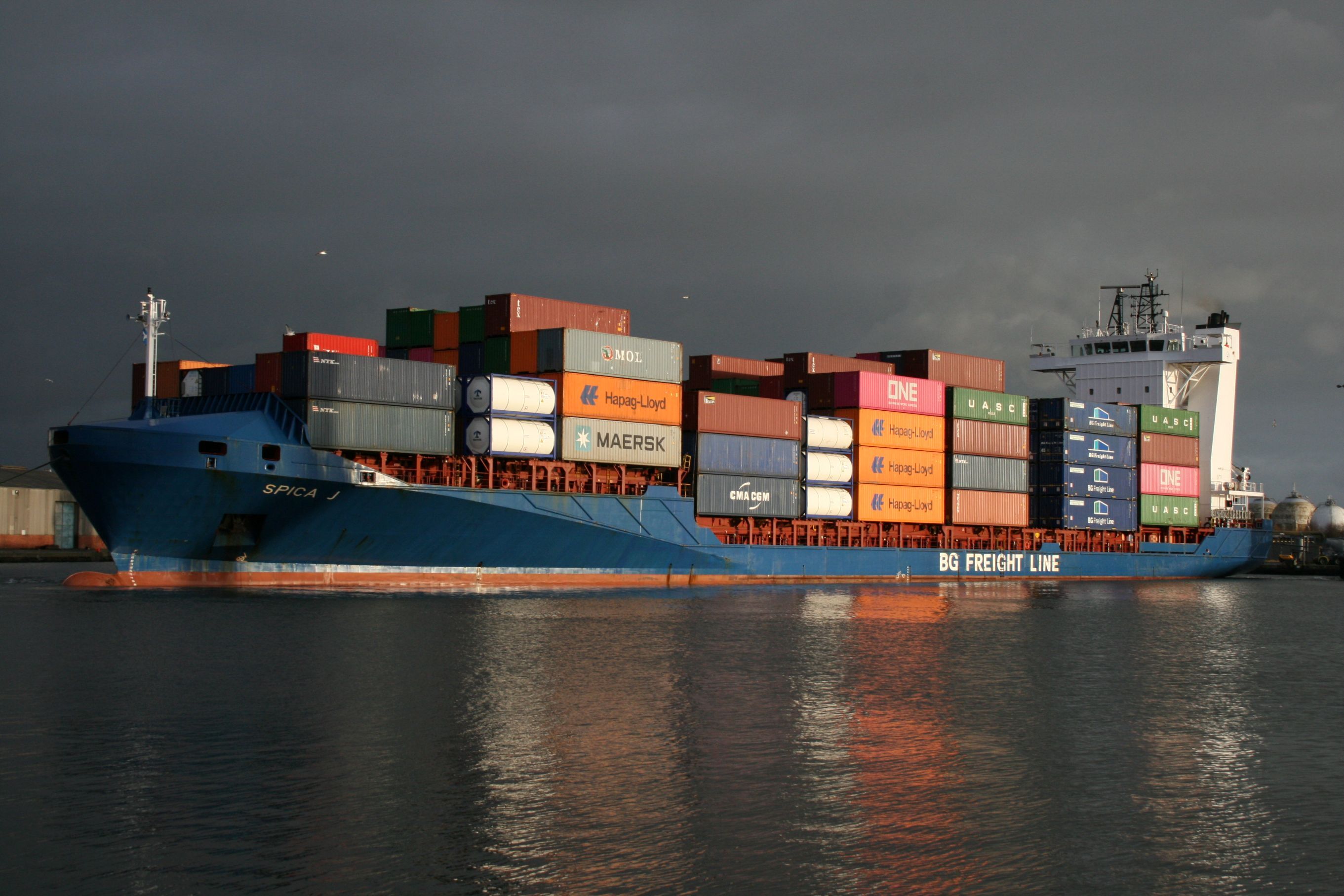 BG Freight Line container ship loaded with multi-brand shipping containers on open water, showing the scale and complexity of freight planning.
